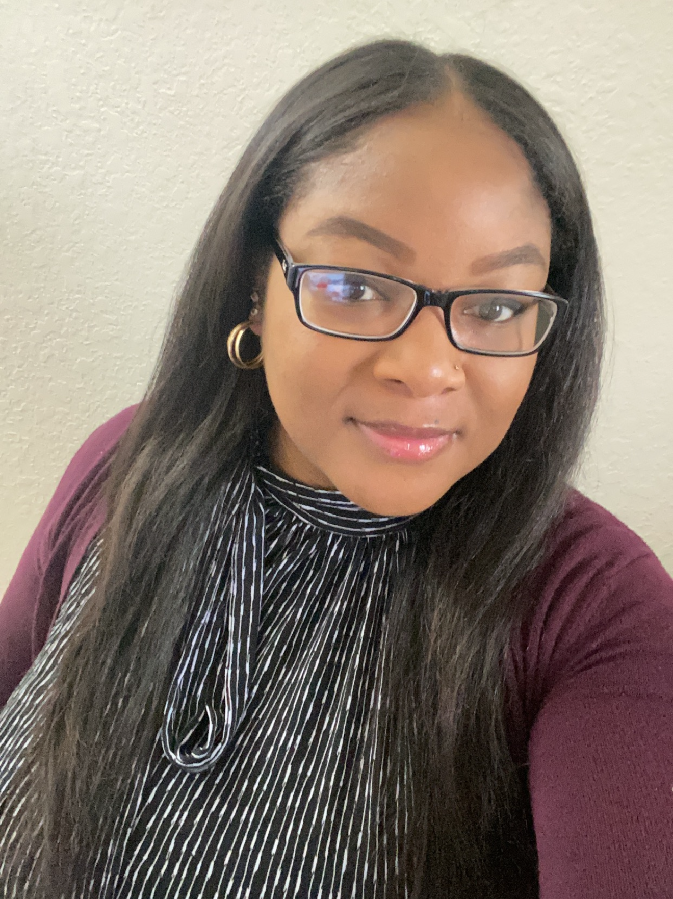 headshot of melissa del valle.  female with red shirt, suit jacket, glasses